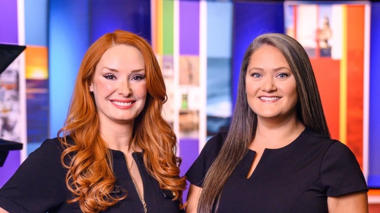 A portrait of two women smiling to camera on the set of a TV program