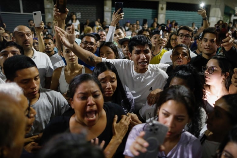 Supporters of opposition candidate Edmundo Gonzalez gather outside the Andres Bello School voting centre, asking for the results, after the polls closed for the presidential elections in Caracas, Venezuela on Sunday, July 28, 2024.