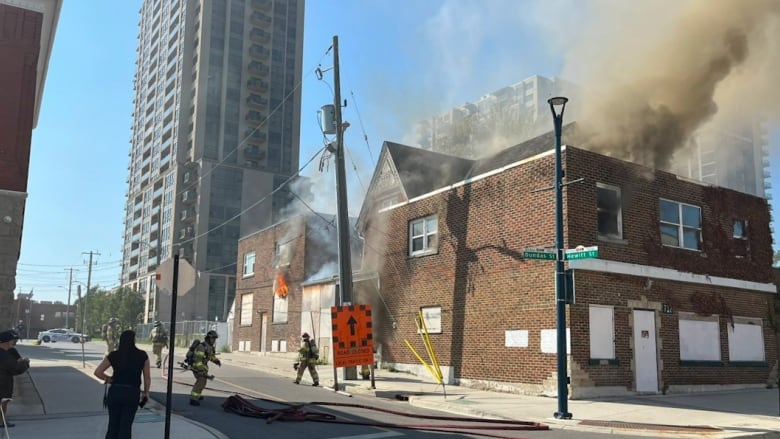 A building at the corner of Hewitt and Dundas streets billowing smoke on Thursday.