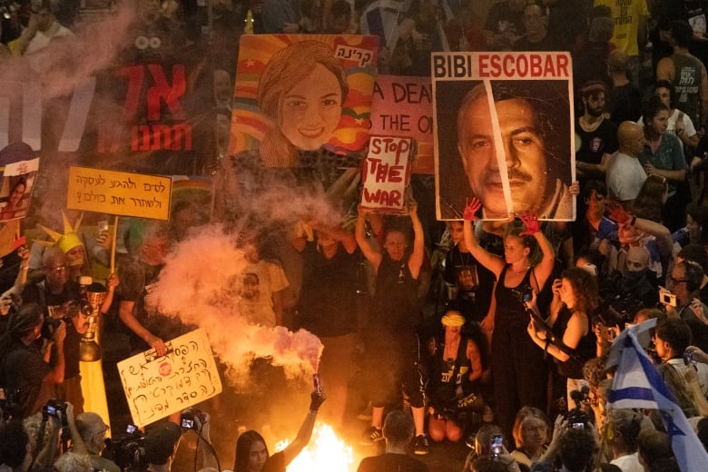 Protesters set a fire and use smoke torches during a demonstration calling for an hostages deal and against Israeli Prime Minister Benjamin Netanyahu and his government on Aug. 17, 2024 in Tel Aviv, Israel.