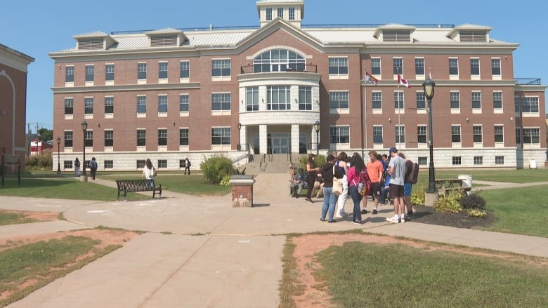 Holland College residence with people standing in front.