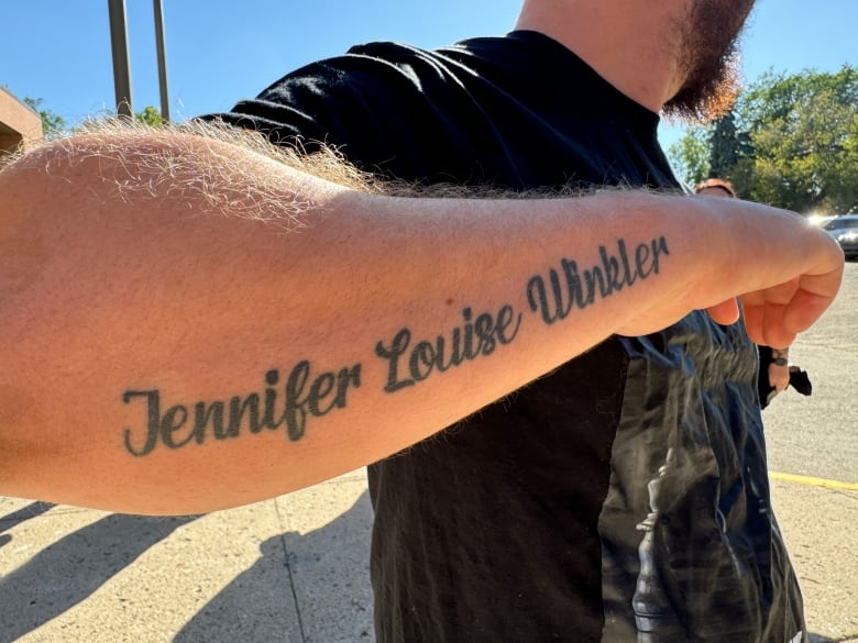 An arm with a tattoo that reads Jennifer Louise Winker