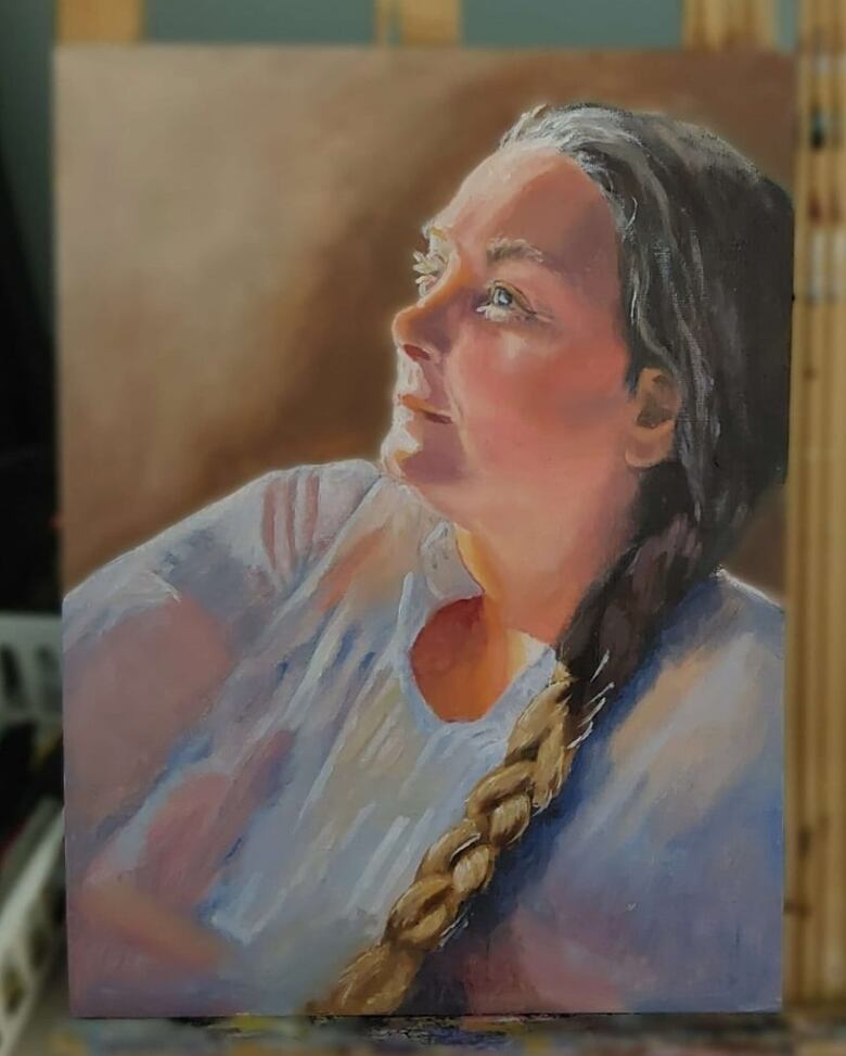 a painting of a woman looking up with a long braid in her hair.