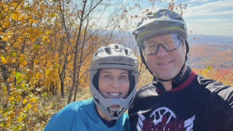 A couple in the mountains posing for a photo.