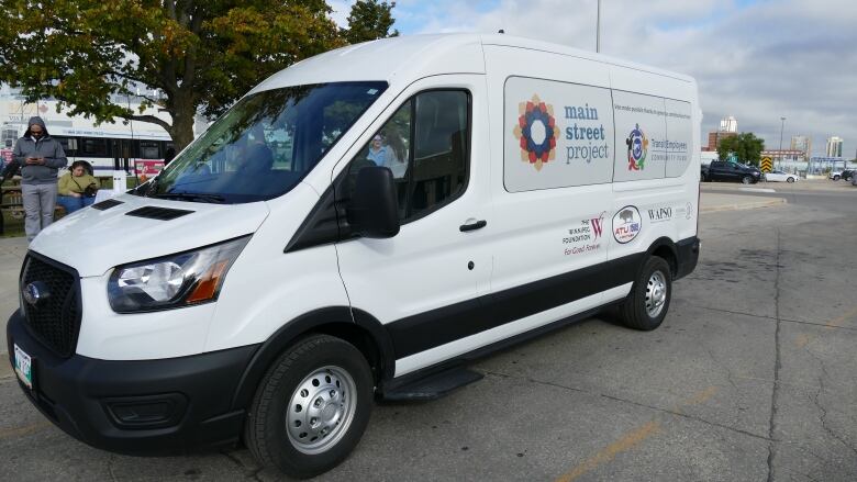 White van with writing on the side.