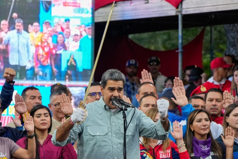 Venezuela's President Nicols Maduro brandishes a sword as his new cabinet takes the oath of office.