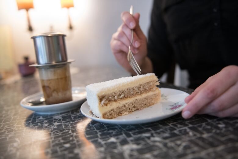 Coffee and cake pictured at a cafe.