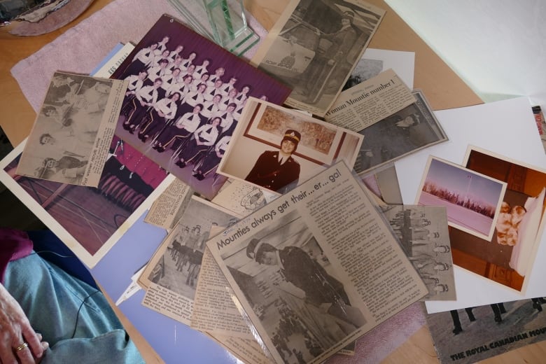 Newspaper and pictures lay on a table