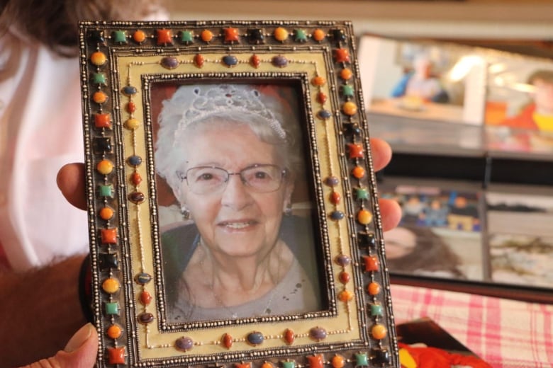 A framed photo of an elderly woman wearing a tiara 