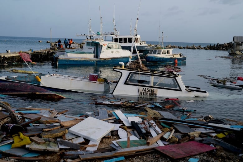 Boats damaged by Hurricane Beryl wade in the water at the Bridgetown Fisheries, Barbados in July.