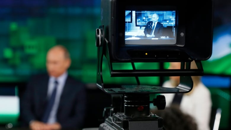 Russian President Vladimir Putin is shown on the screen of a camera viewfinder at the new headquarters of the Russia Today television channel in Moscow, Russia on Tuesday, June 11, 2013. 