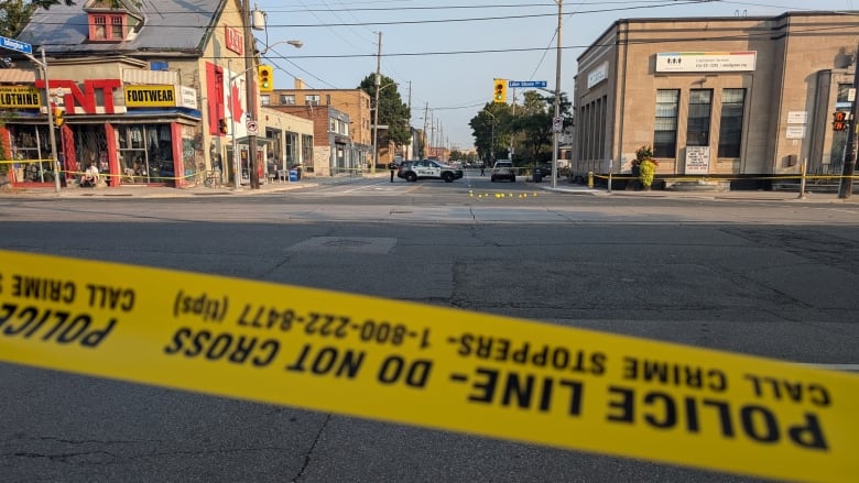 Police tape is seen at the edge of a crime scene on a Toronto street.