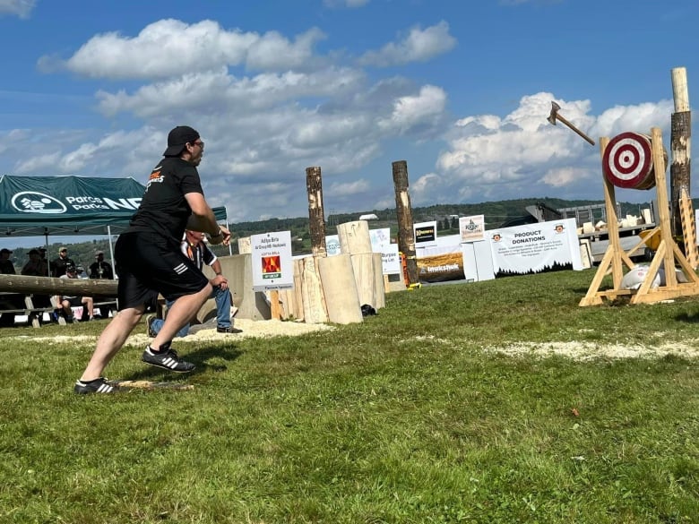 A man throwing an ax at a bullseye