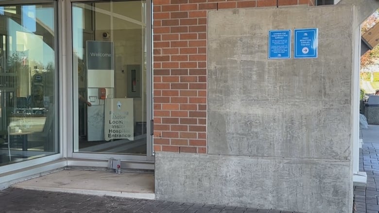 An empty concrete plaform in front of a window. 