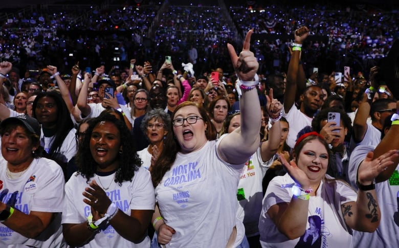 A group of female supporters in 'North Carolina' T-shirts cheer