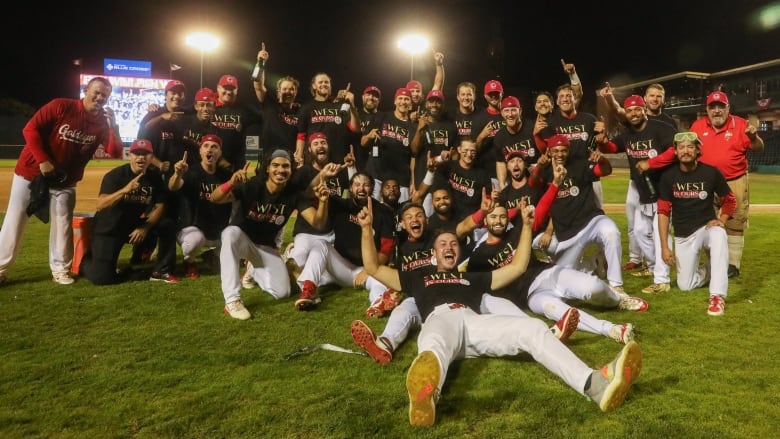 Baseball players celebrate on the field