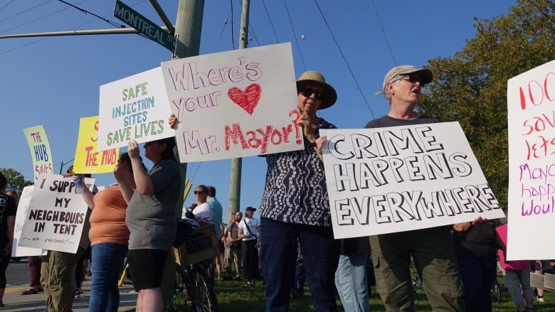 People are seen holding signs in protest 