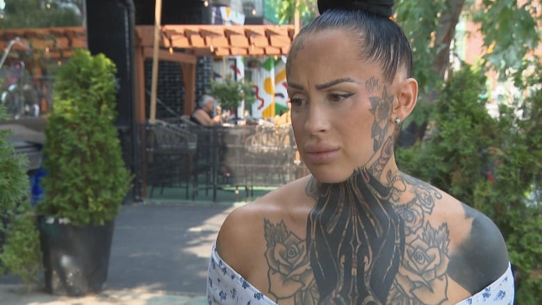 Photo of a woman with her hair in a bun outside