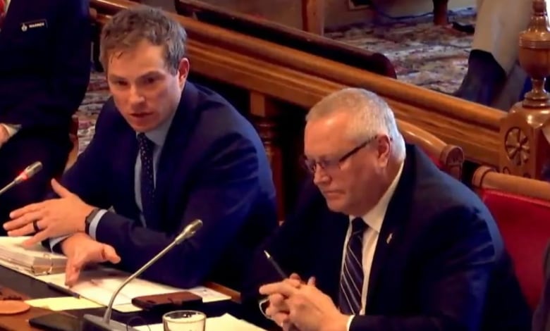 Two men sitting at a table in the legislature