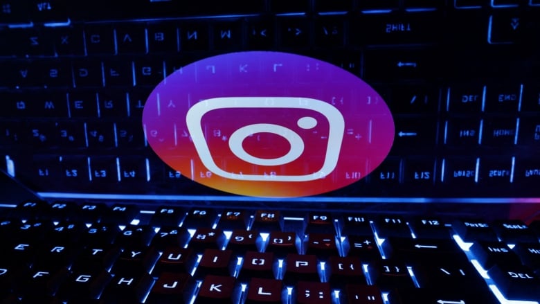 A keyboard is shown, as well as the pink logo for the app Instagram.