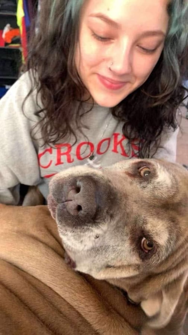 A girl with a dog on her lap