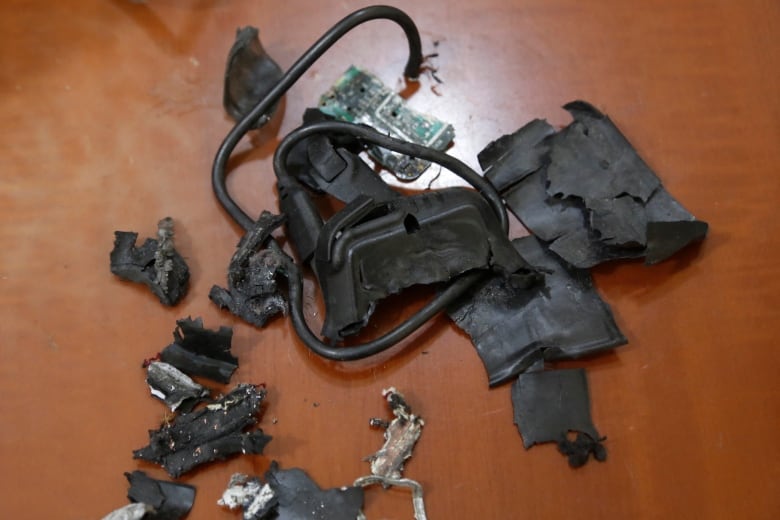 Remains of an exploded pager on display on a surface.