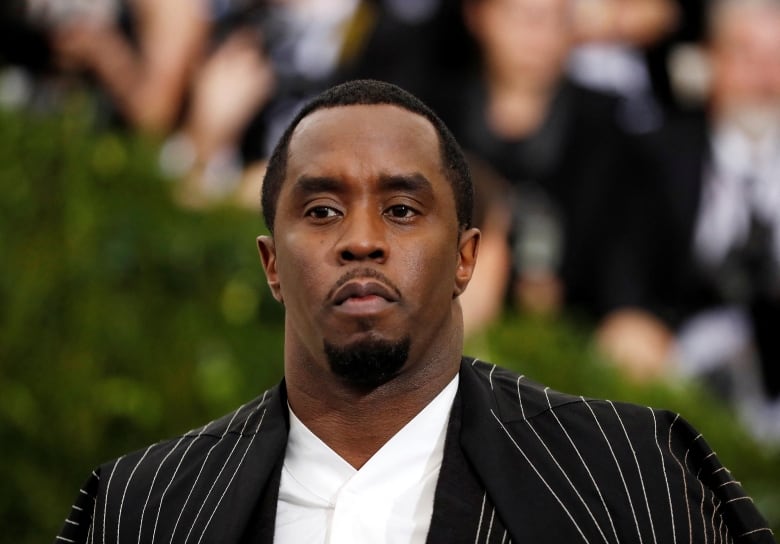 Sean (Diddy) Combs in a black and silver spider web suit and cape arriving at the Metropolitan Museum of Art Costume Institute Gala in New York City in 2017.