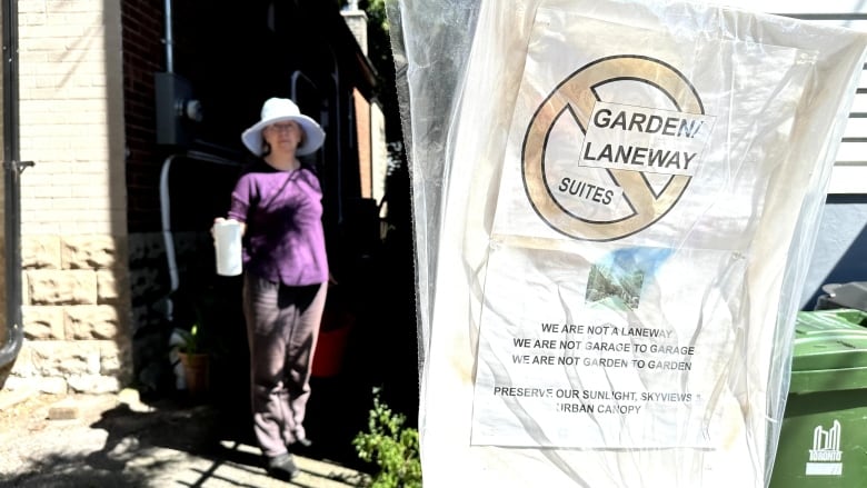 A sign on a pole shows a prohibit symbol with the words garden laneway suites inside.