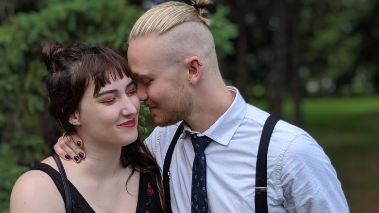 A man and a woman pose for a couple's photo.