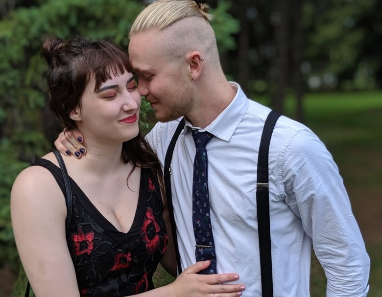 A man and a woman pose for a couple's photo.