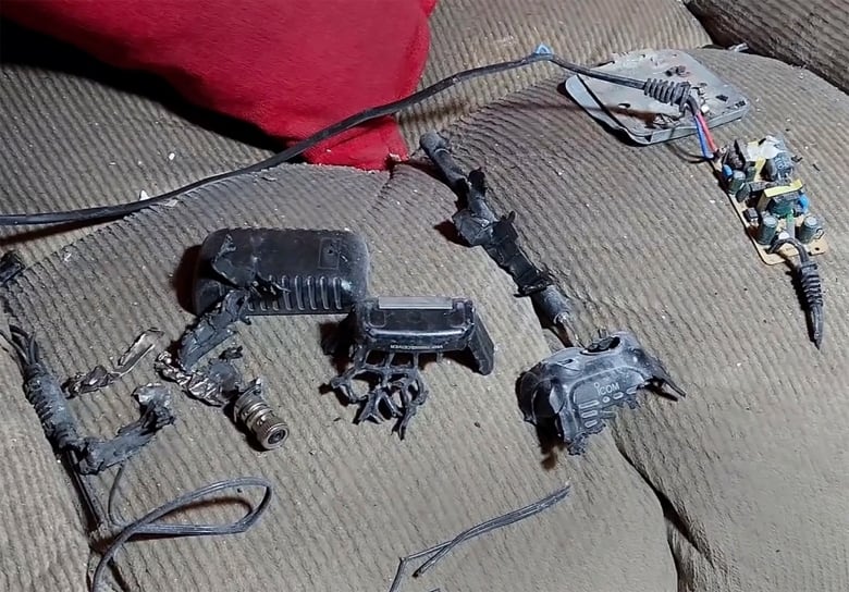 A walkie-talkie is pictured in pieces after it exploded.