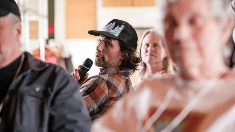 Sam Oettli asks a question during a citizen's assembly meeting on electoral reform. 