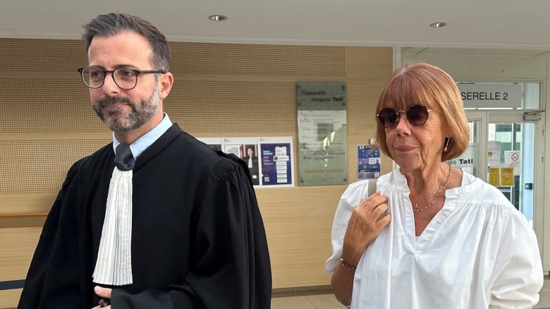 An older woman walks into a courthouse with a lawyer