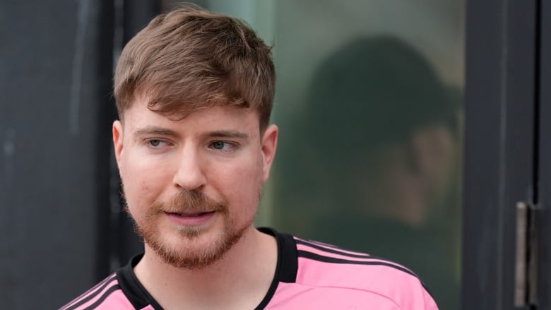 Close-up of a man in a pink jersey. 