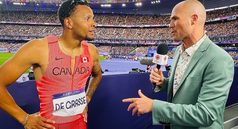 CBC Sports senior reporter Devin Heroux interviews Canadian men's sprinter Andre De Grasse at the Paris Olympics in August 2024.