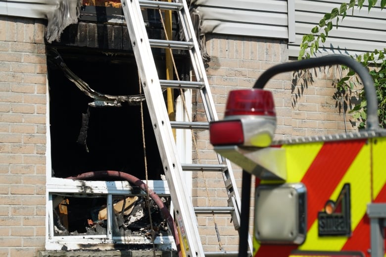 One of several blown out windows that could be seen on the structure, Thursday.