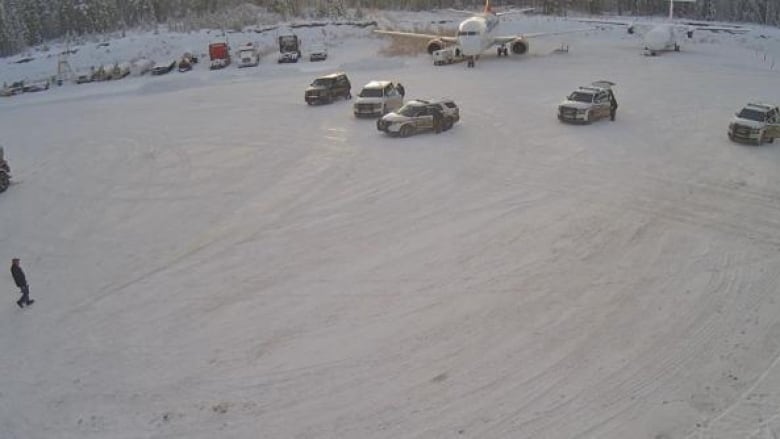 A photo included in the report shows the man approaching RCMP at the Air North hangar in Whitehorse. 