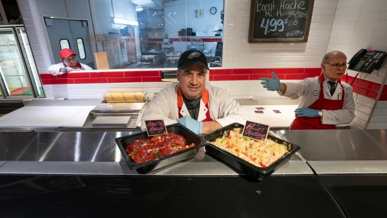 three men at deli counter