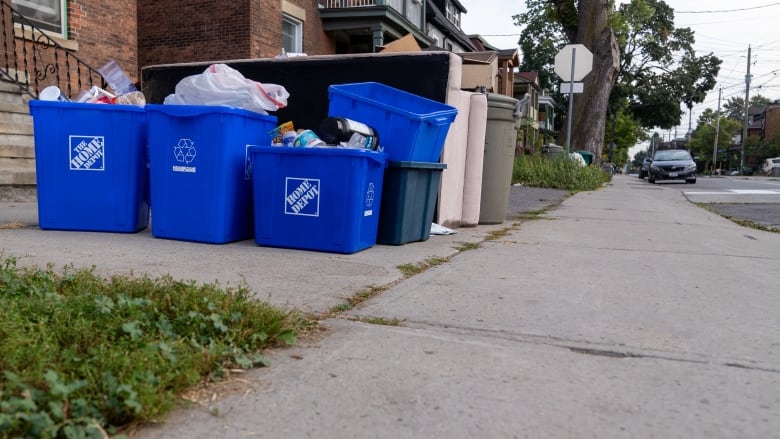 Recycling bins and a couch