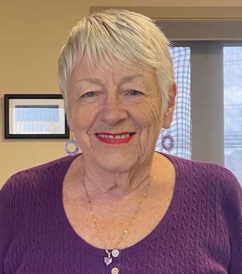 A smiling woman with short, grey hair.