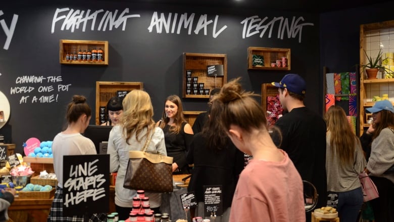 Holiday shoppers check on discounts at a Lush cosmetics store. 