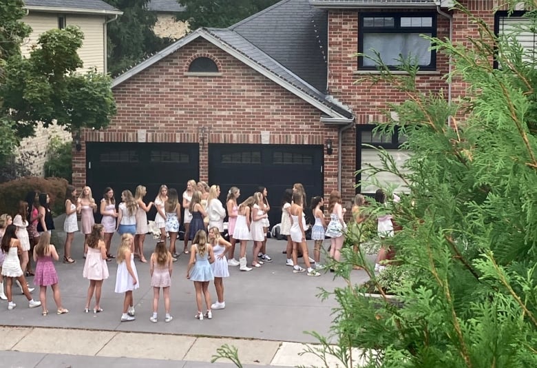 Dozens of women wait for instructions as they arrive and leave by the busload at 167 Sunnyside Drive, a home that's being rented out as a short-term rental. 