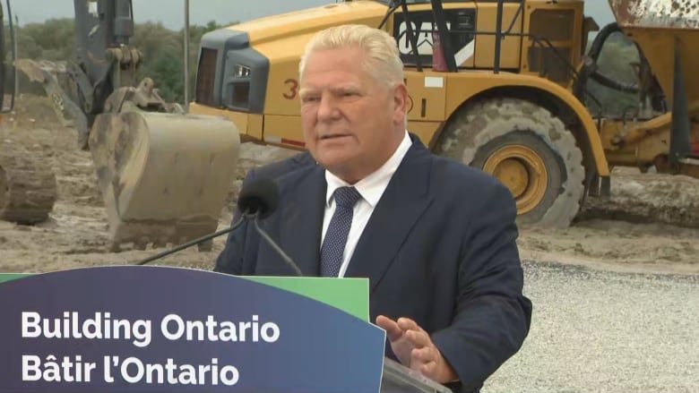 Ontario Premier Doug Ford stands at a news conference podium in Cobourg, Ont.