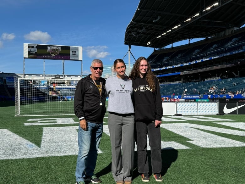 University of Manitoba Bison men's football head coach Brian Dobie, Amlie Beauregard and Maya Turner at the stadium shared by the Bisons and the CFL's Winnipeg Blue Bombers.