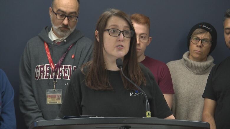 A woman speaks from a podium.