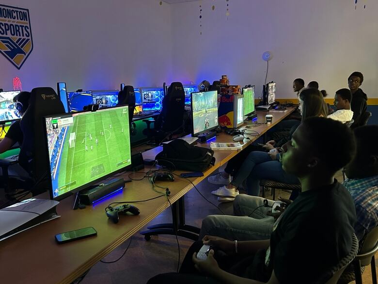 A room full of people playing video games.