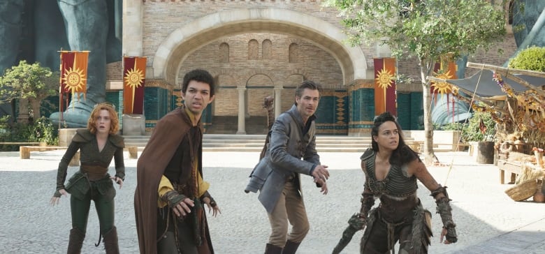 Four adventurares stand in a courtyard in a still from the movie Dungeons & Dragons: Honor Among Thieves