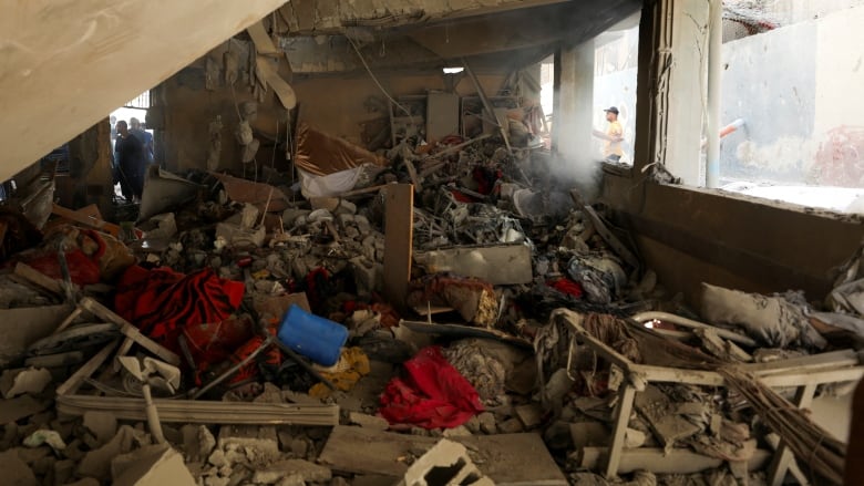 Palestinians inspect a school that was destroyed. 