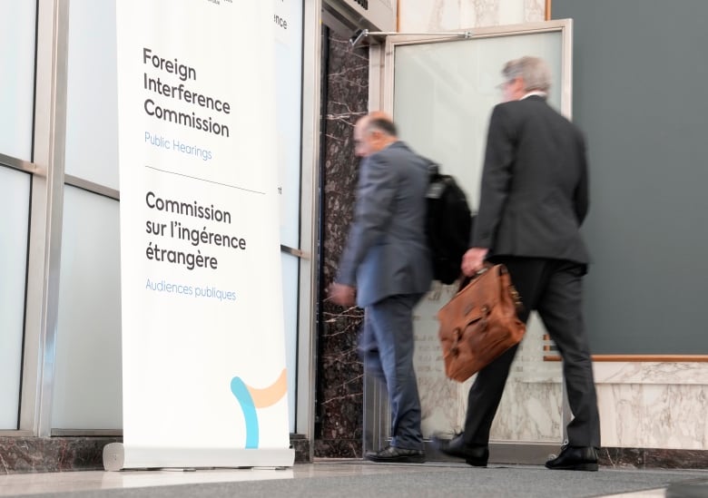 Lawyers enter the hearing room as the Public Inquiry into Foreign Election Interference resumes in Ottawa, Monday, Sept. 16, 2024.