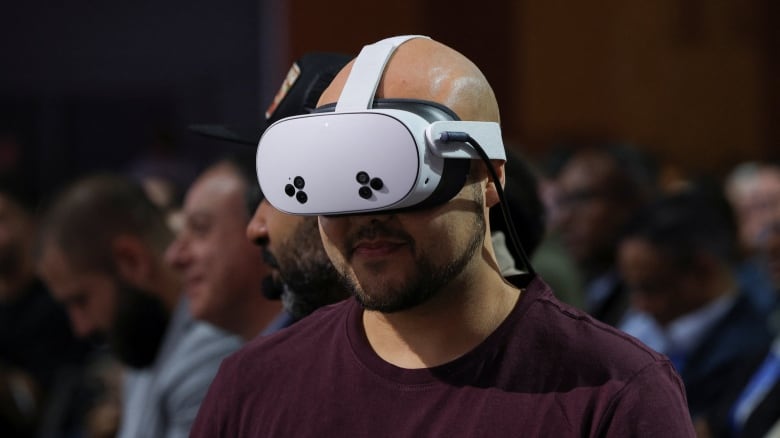 A man wears a VR headset which covers his eyes. 